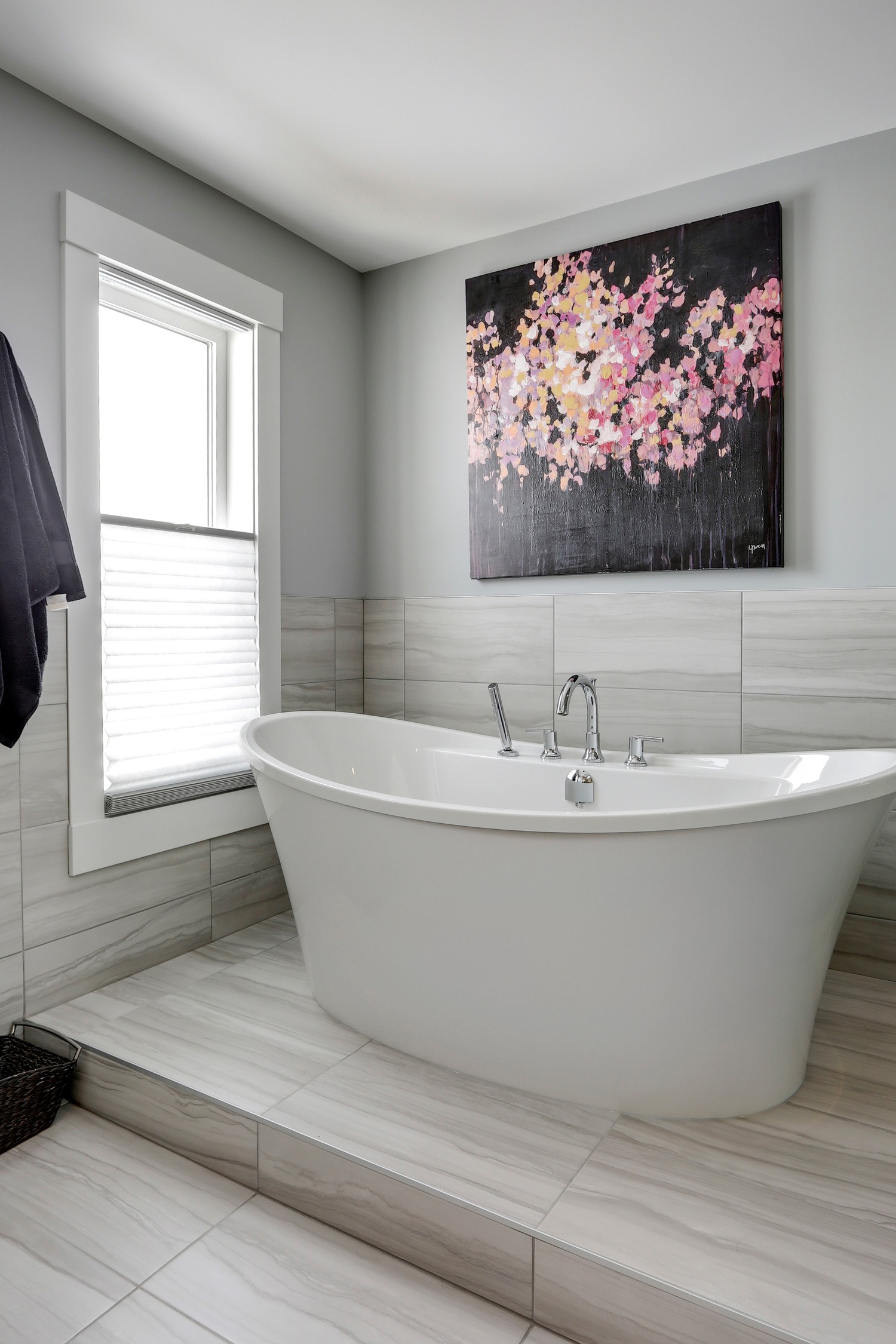 Spa-inspired ensuite with freestanding soaker tub on raised platform