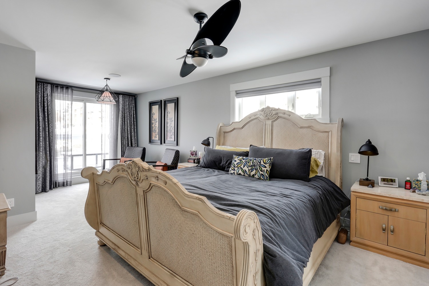 Primary suite with balcony access and ceiling fan