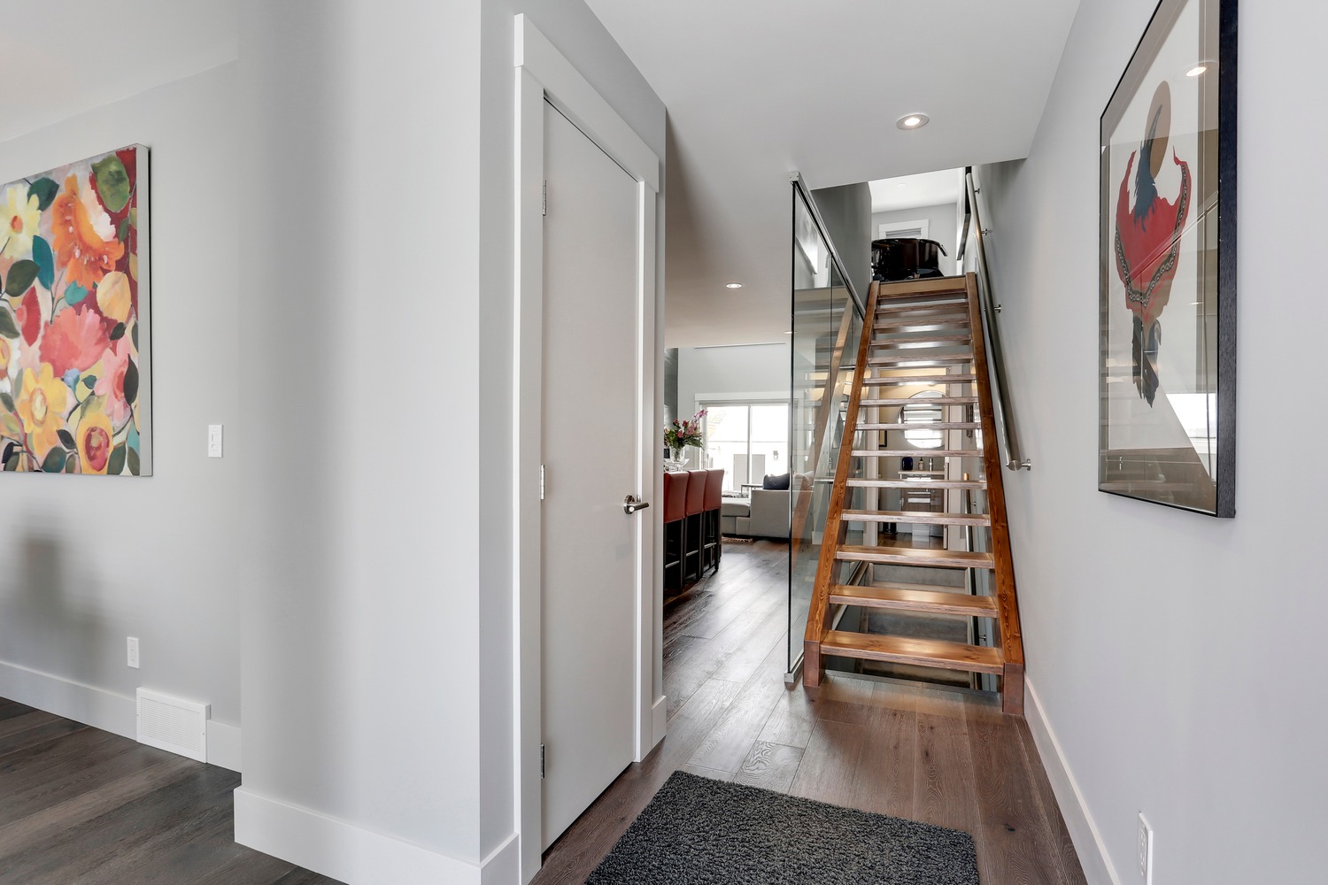 Entry hallway with open-tread staircase and hardwood flooring