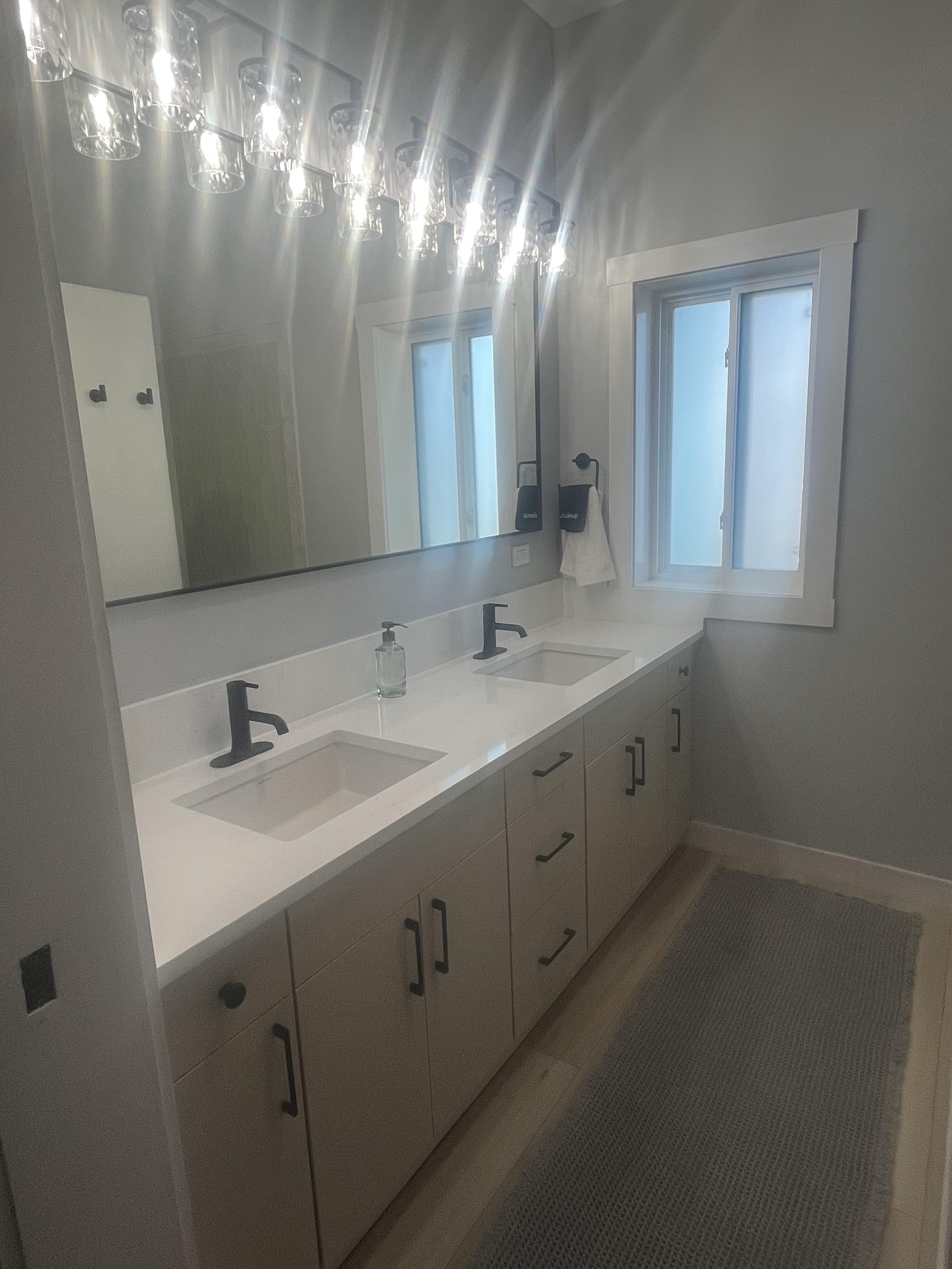 Built-in floating shelves and matte black hook rail